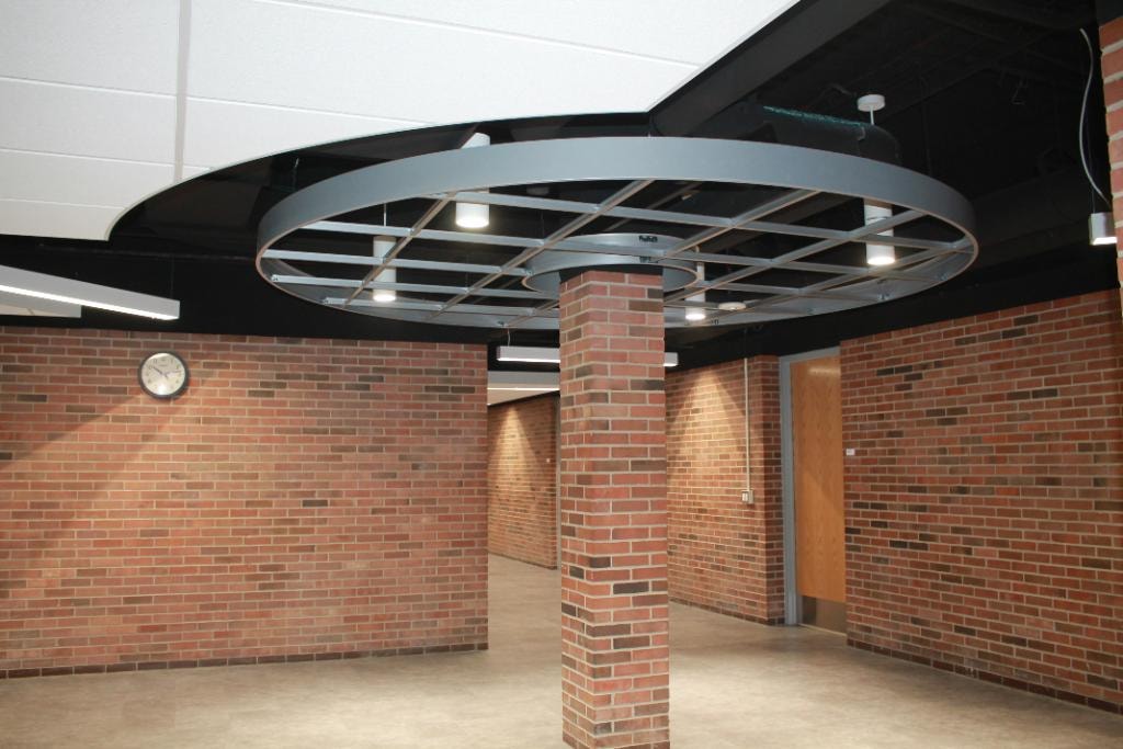 Modern ceiling fixture in brick interior space